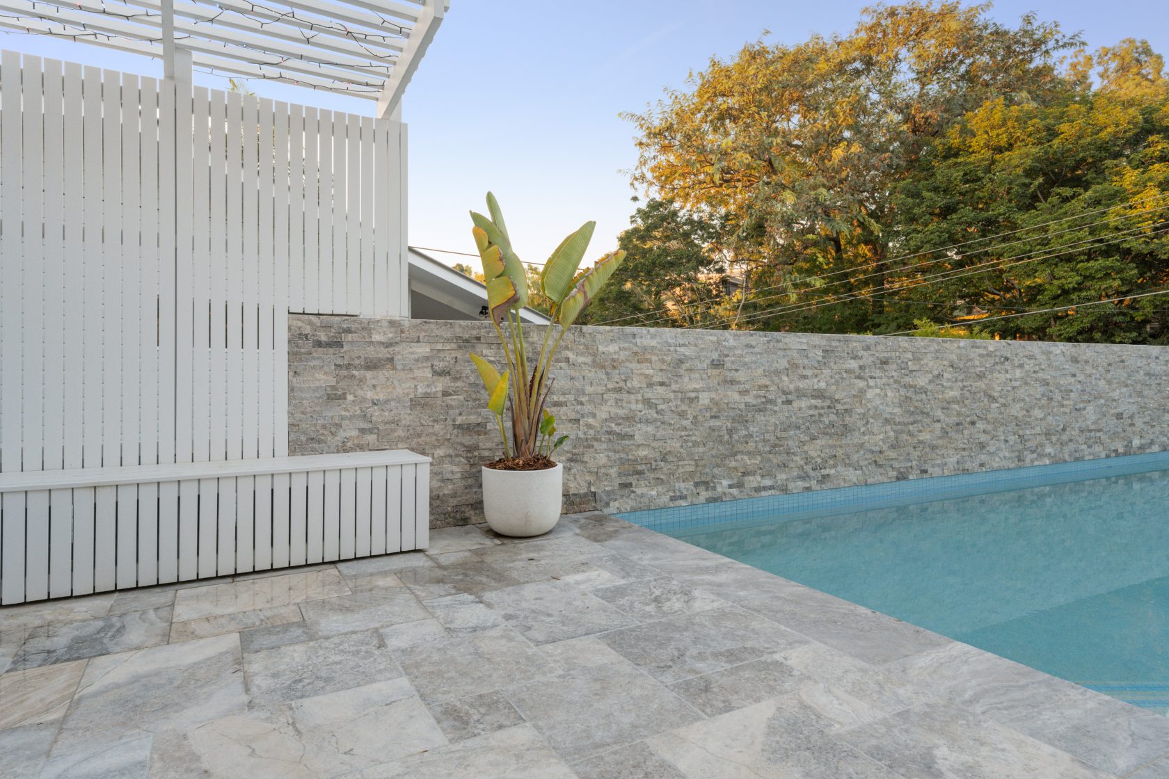 Silver Travertine walling, Silver Travertine coping and surrounds and Ice Blue waterline