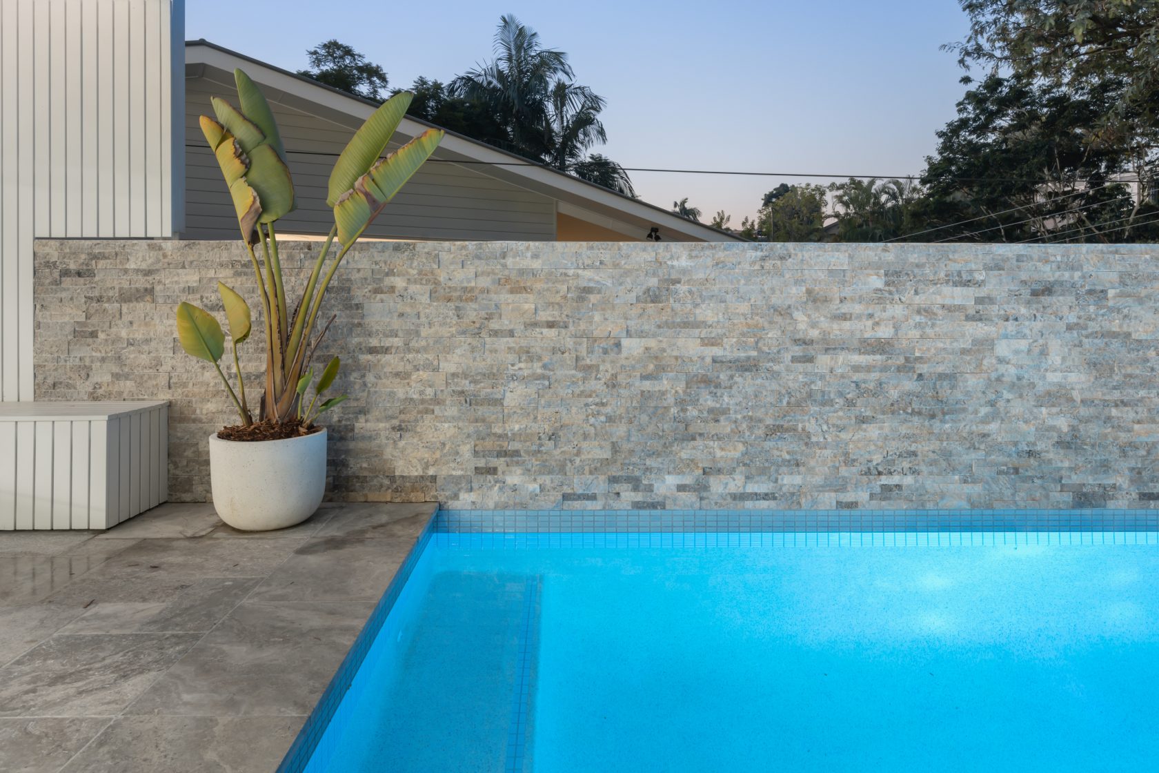 Silver Travertine walling, Silver Travertine coping and surrounds and Ice Blue waterline