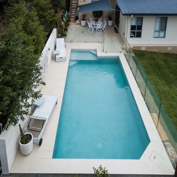 Pluto dropface porcelain pool coping and surrounds with Urban White Waterline tiles and Thredbo walling